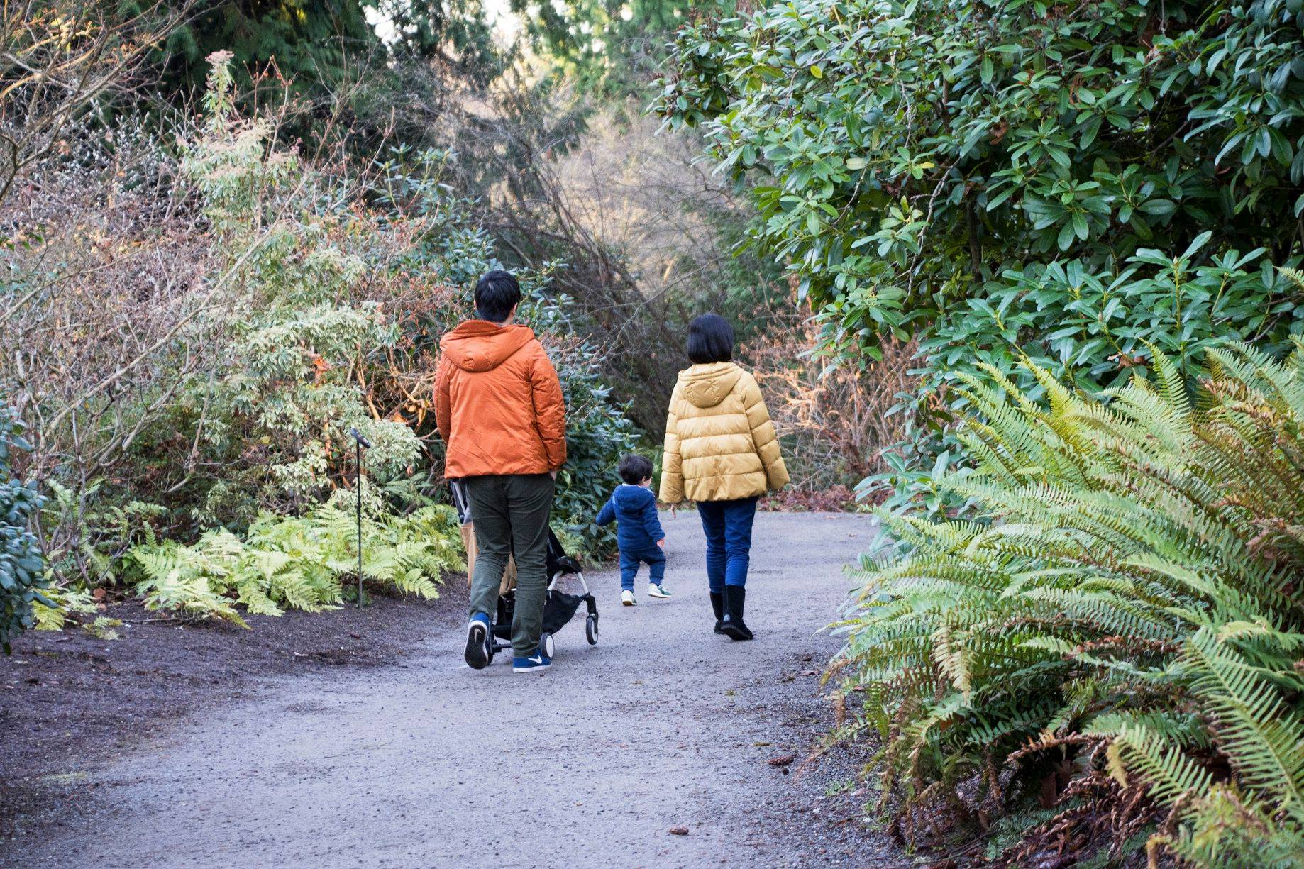 A family walking in fall or winter at Bellevue Botanical Garden