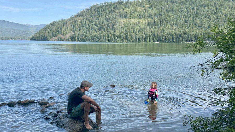 father and daughter in Priest Lake enjoying the sunshine