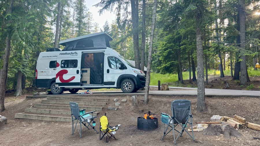 camping chairs outside the roadsurfer rental van with everything set up