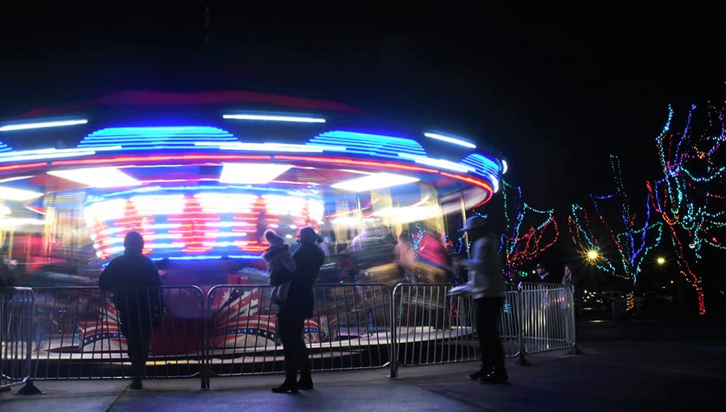 Kids ride the carousel merry-go-round at the Washington State Fair's Holiday Magic holiday season event family fun near Seattle