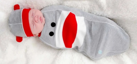 Baby wearing a sock monkey costume