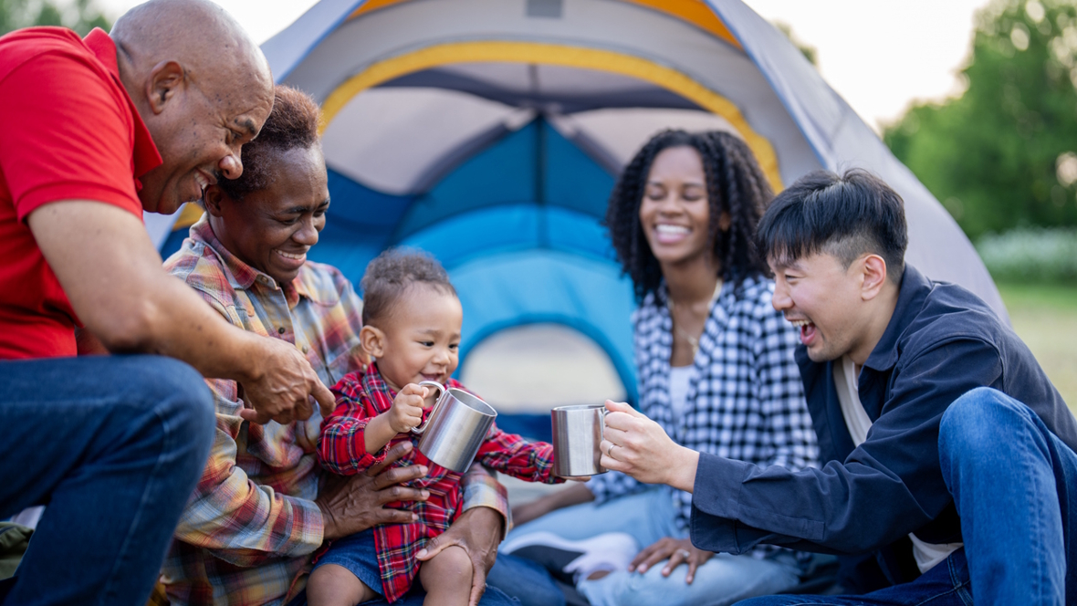 parents, grandparents and a baby camping and have fun