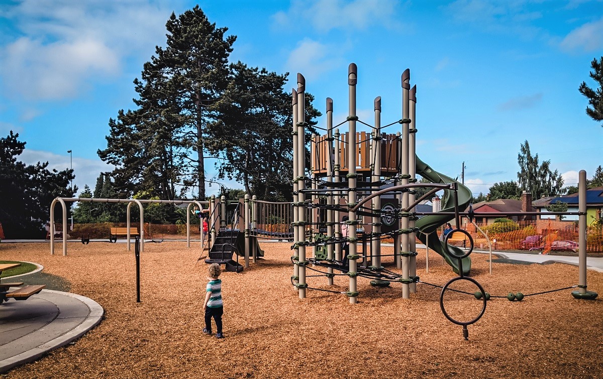 View of children playing at new Loyal Heights Playfield playground opened June 2021