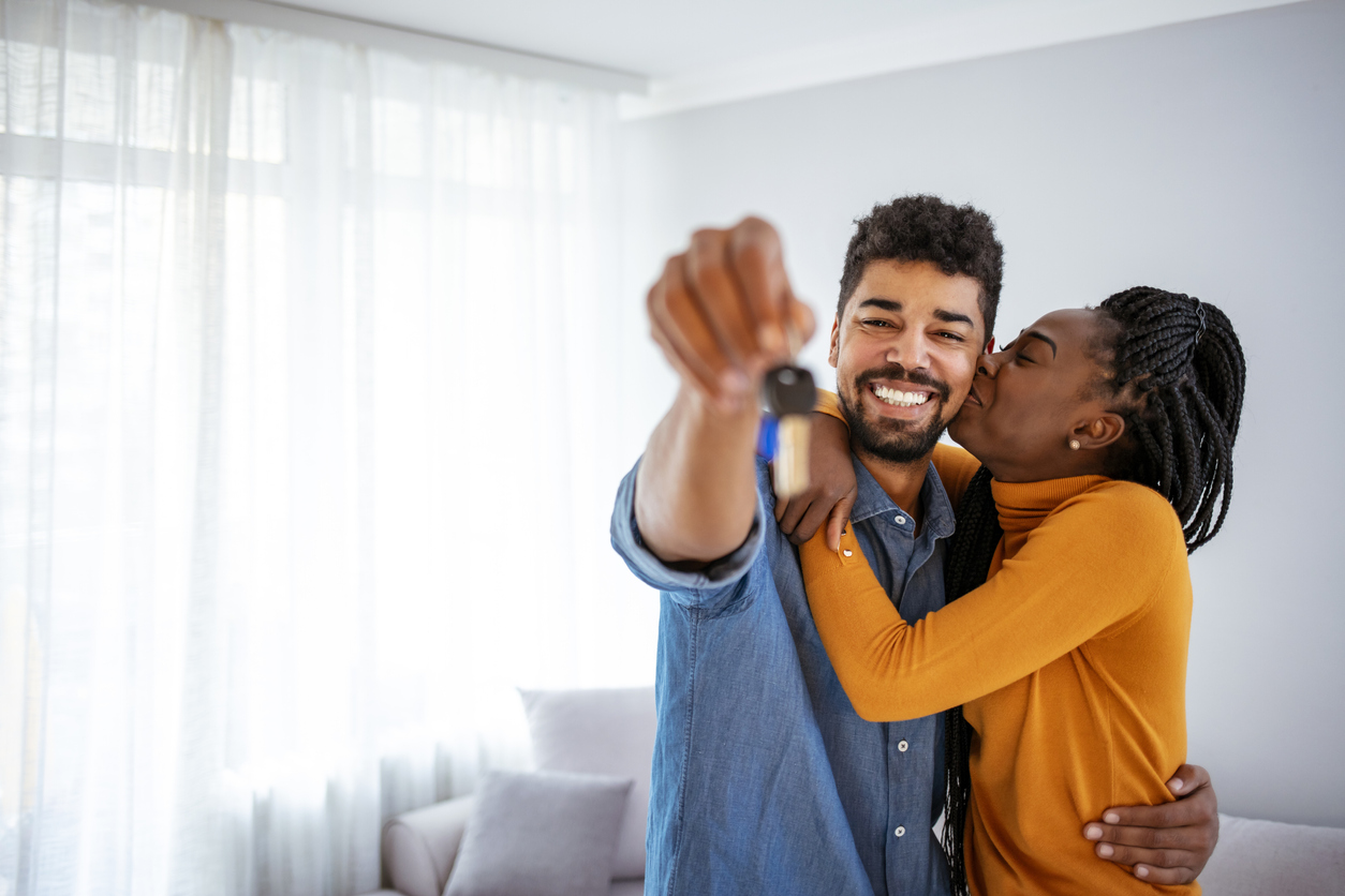 happy couple with the keys to their new home