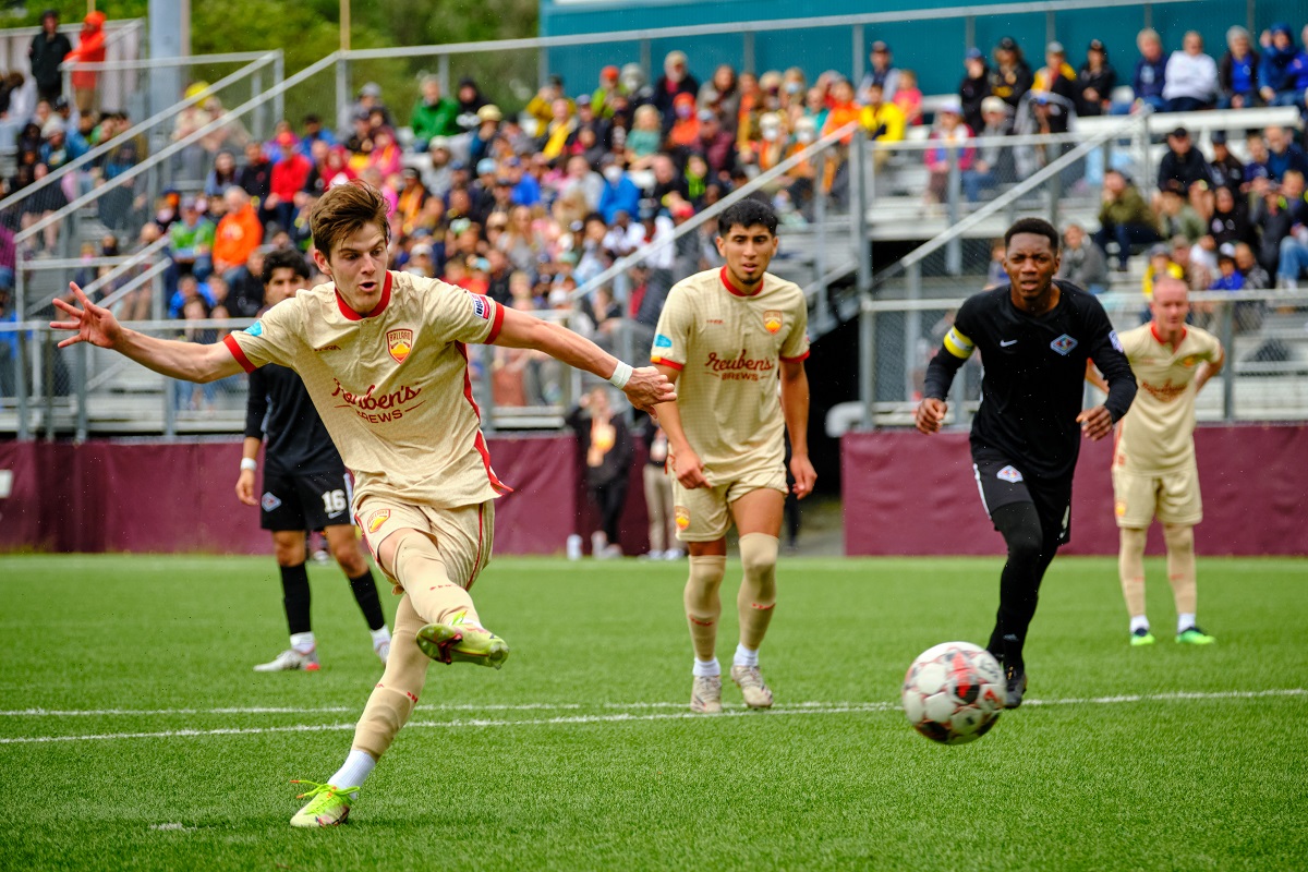 Ballard FC player takes a shot during a USLeague two match in 2022, Ballard FC's inaugural season in Seattle