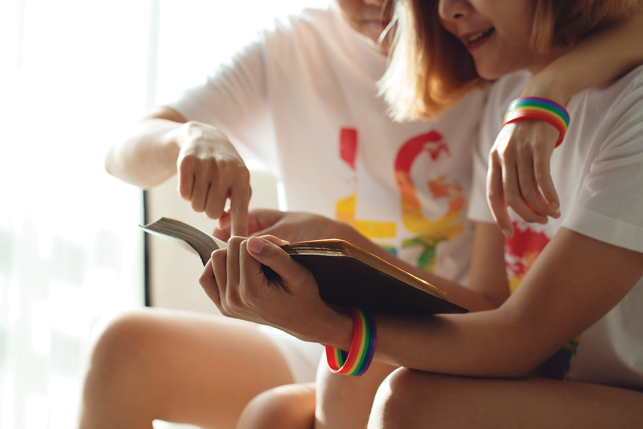 Two children reading a book together