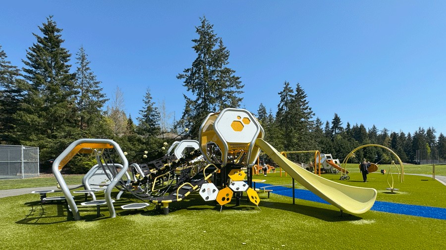 overall view of Hidden Valley Park playground with climbing structures, swings and more