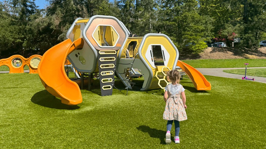 young girl at climbing structure for ages 2–5 at new playground in bellevue