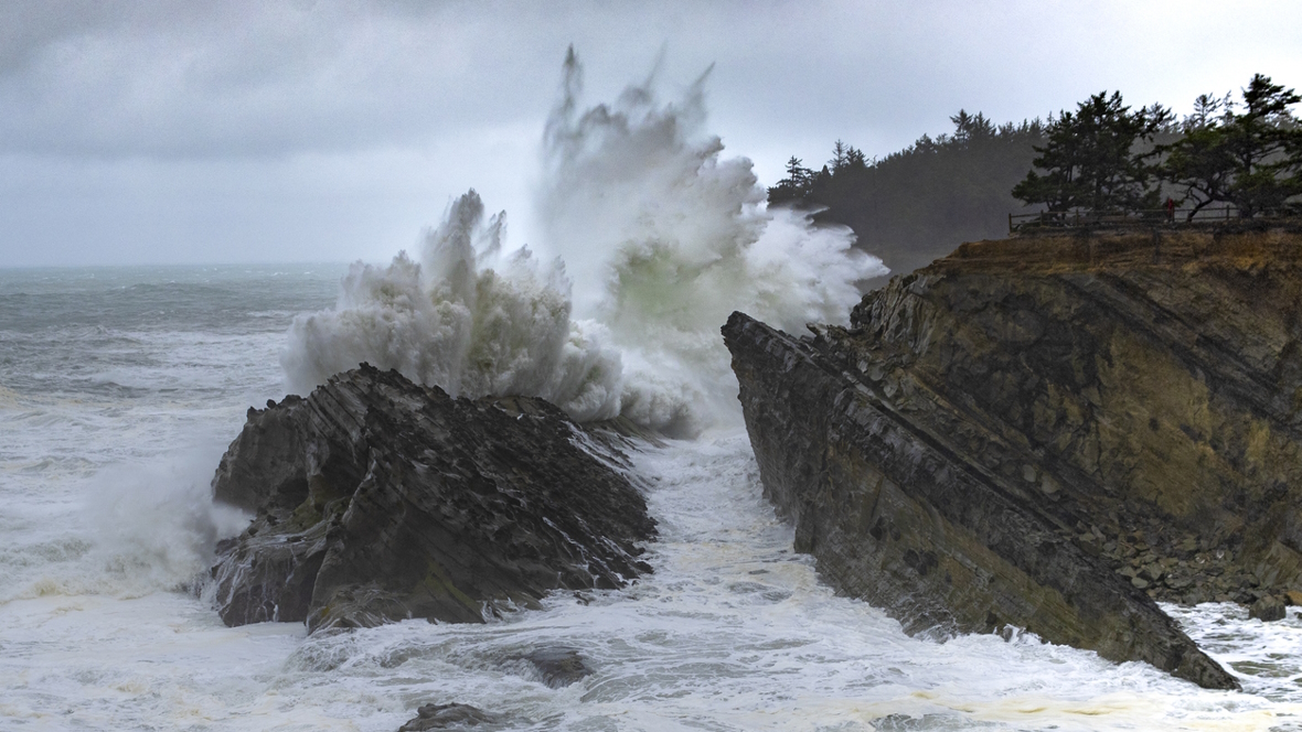 Huge waves smash into a rock during a storm on the Oregon coast