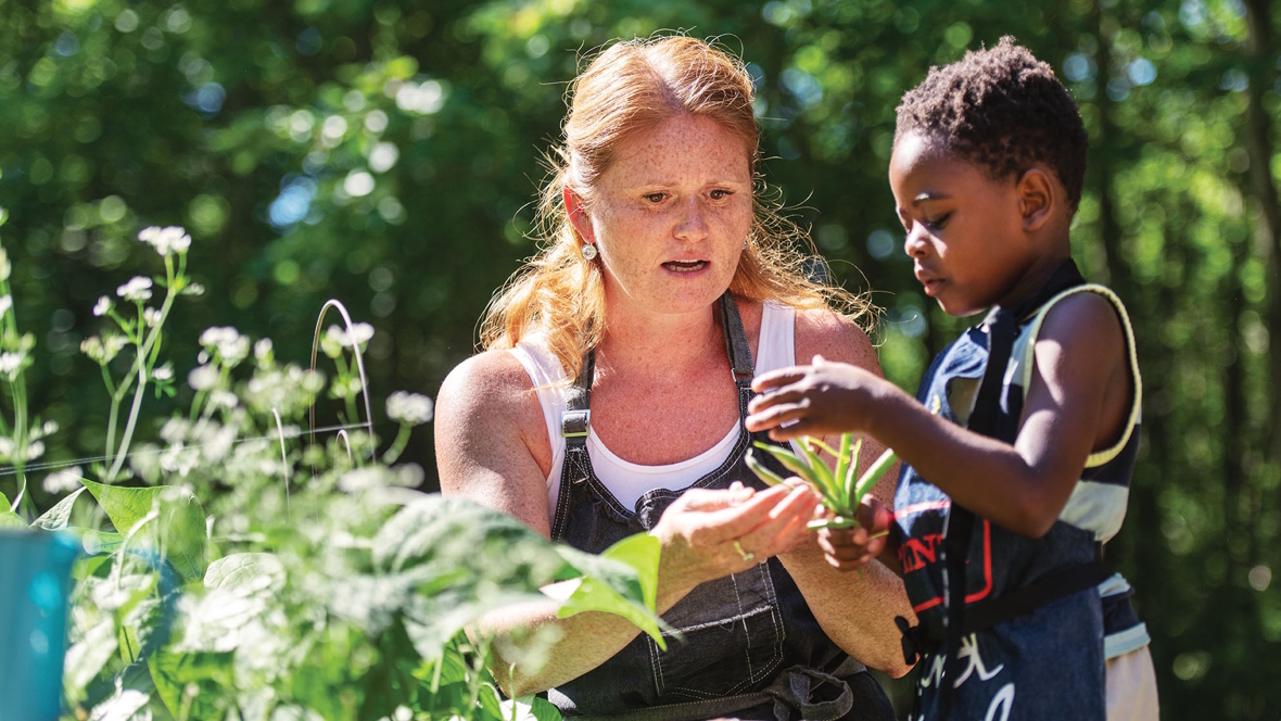 woman with a little boy in a garden