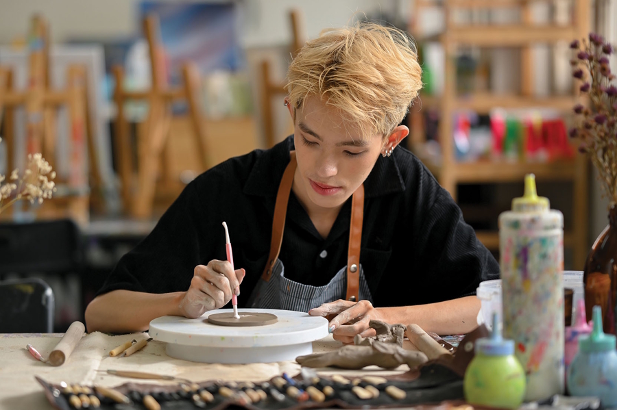 Teen making pottery in a hands-on art class