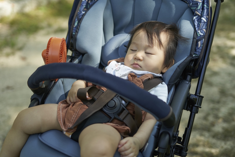 baby sleeping in a stroller
