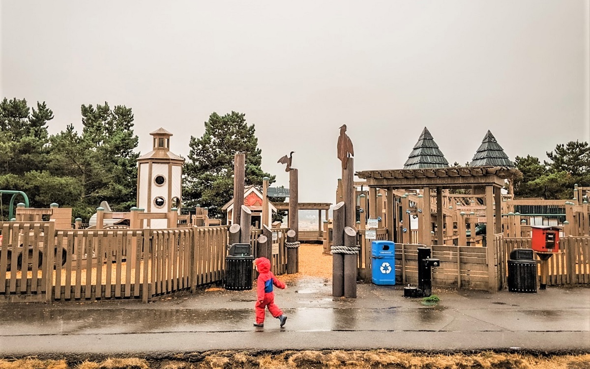 On a gray fall day, kids play at Playground by the Sound at Chambers Creek Regional Park in University Place near Tacoma one of Puget Sound area’s biggest parks