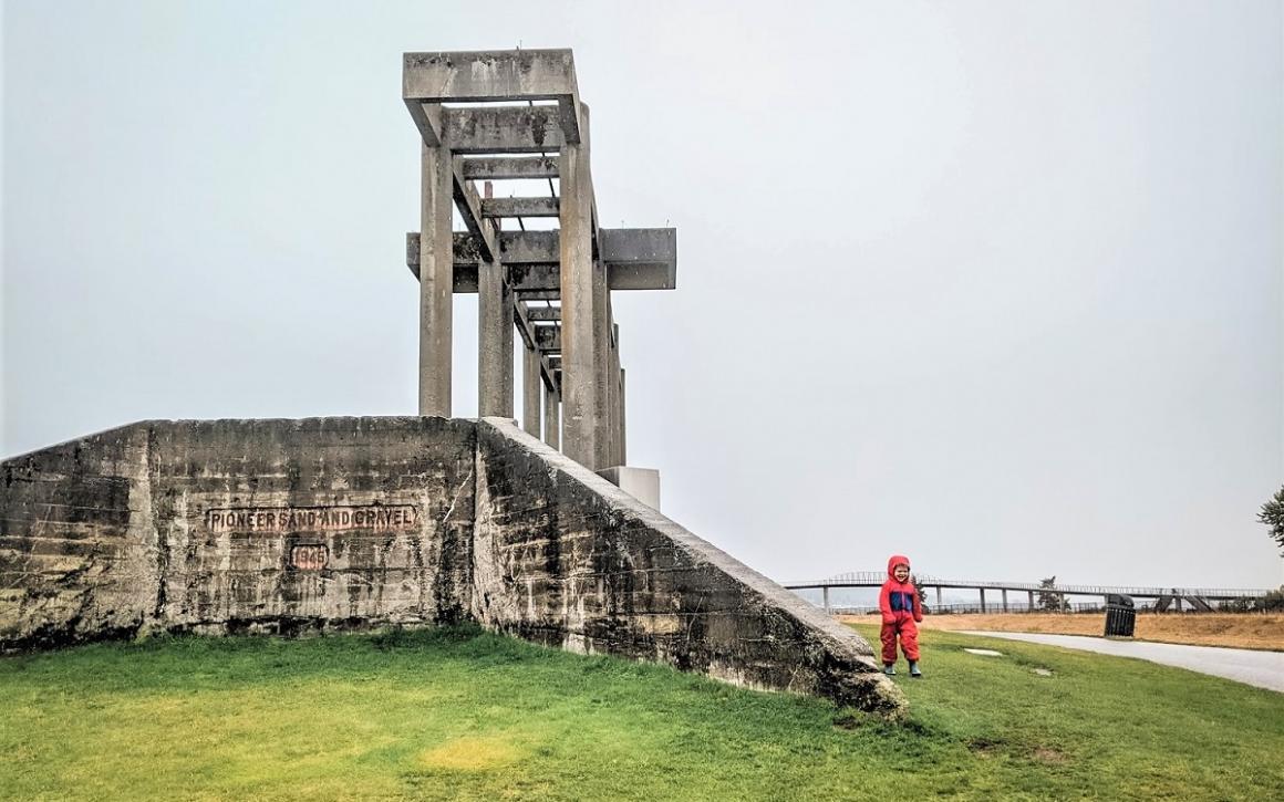 Boy playing on ruins of gravel mine at Chambers Bay a large park in the Puget Sound area