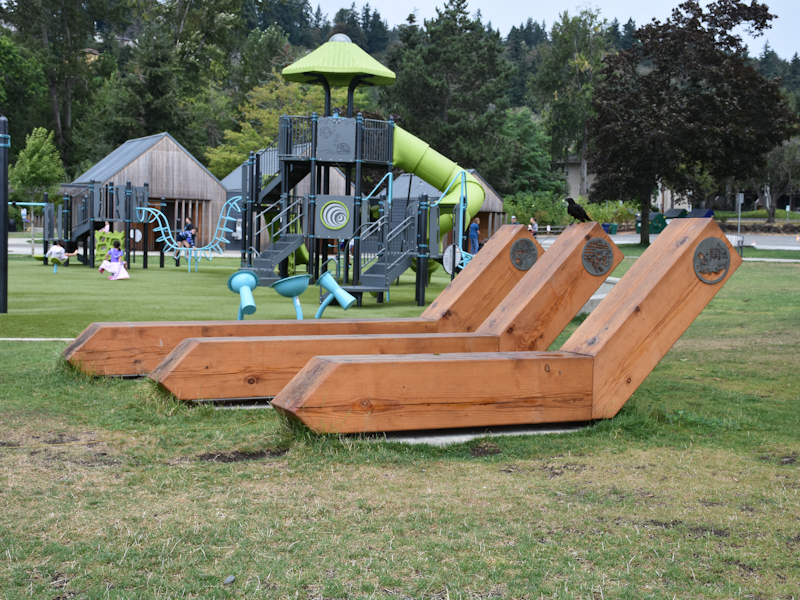 Kids play at Juanita Beach Park's updated lakeside playground on a drizzly winter day near Seattle
