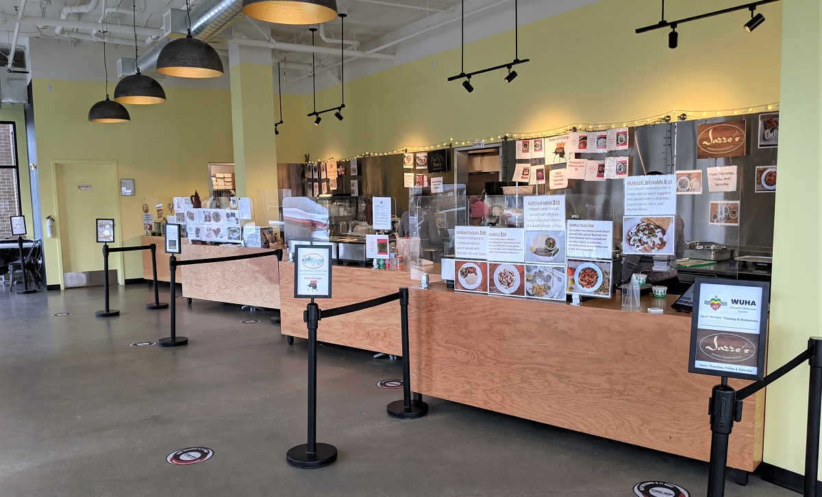 Wide shot of the interior and food stalls of Spice Bridge Food Hall global cuisines Seattle Tukwila where to eat with kids