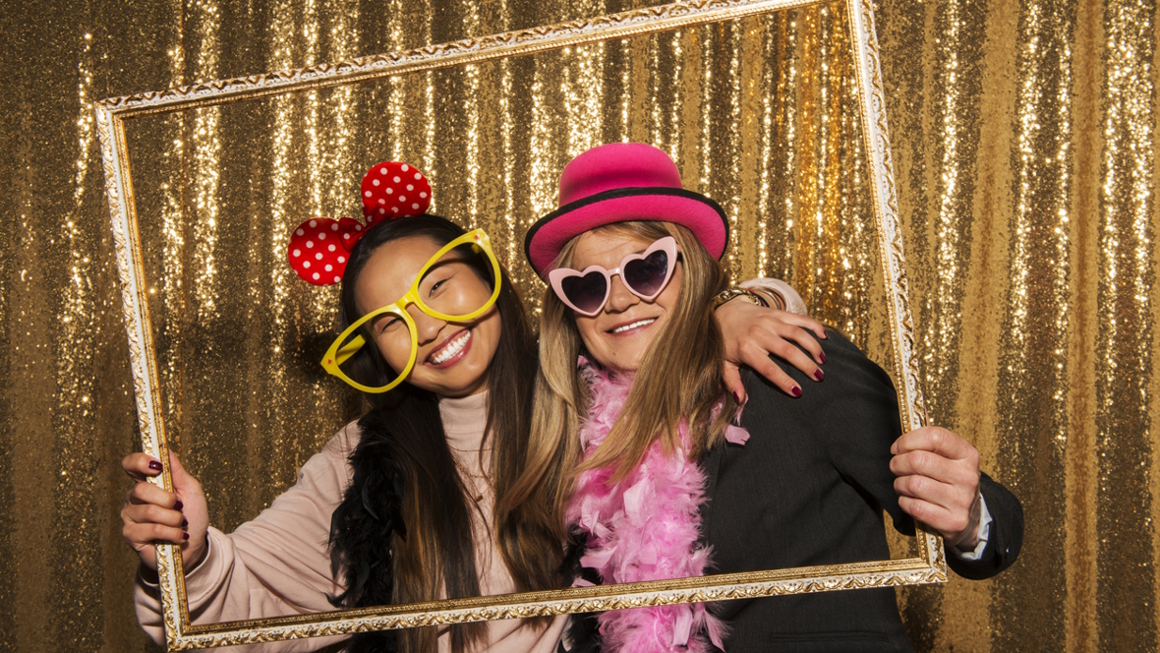 people in a photo booth at a party