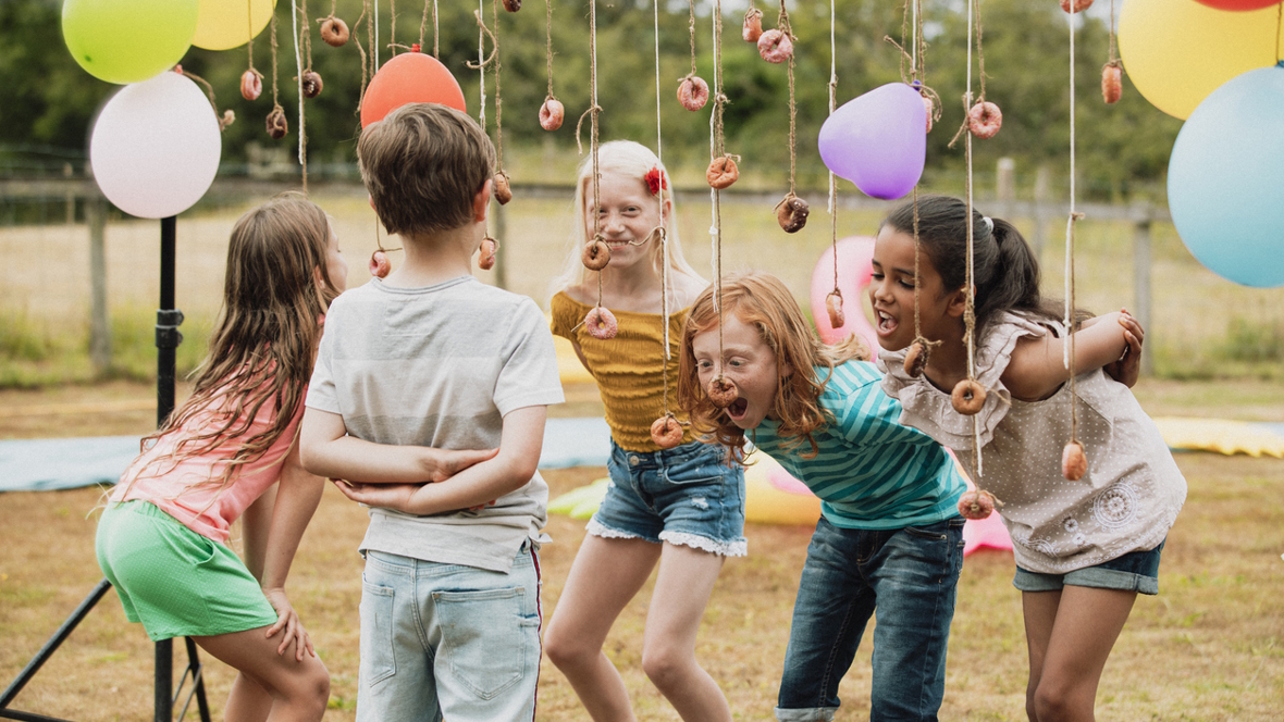 kids eating donuts on a string