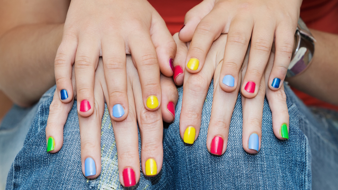 hands with multi-colored nail polish