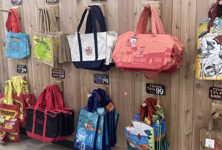 tote bags on the wall at Trader Joe’s