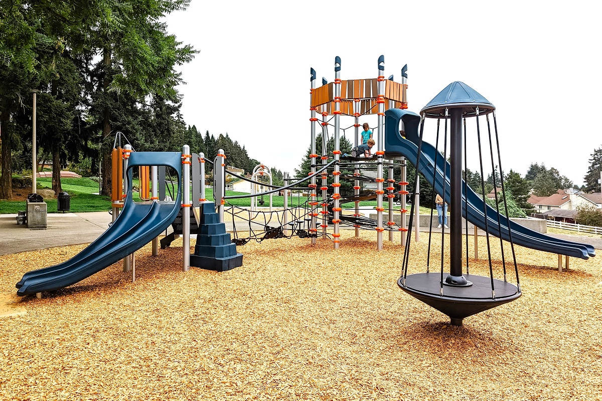 Kids play on the new play structure at just renovated Chestnut Ridge Park playground in Kent