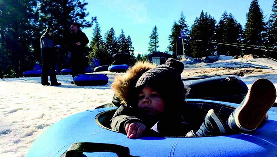 Little boy in a snow tube