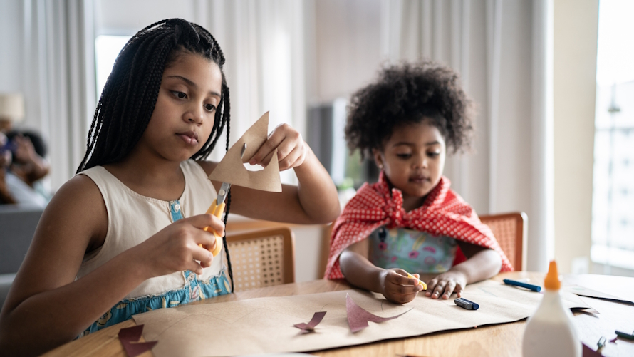 Sisters making Thanksgiving crafts together