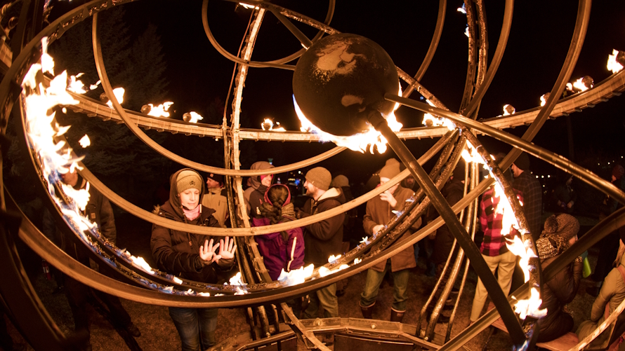 Things to do in Bend Oregon, woman warming her hands at Winterfest