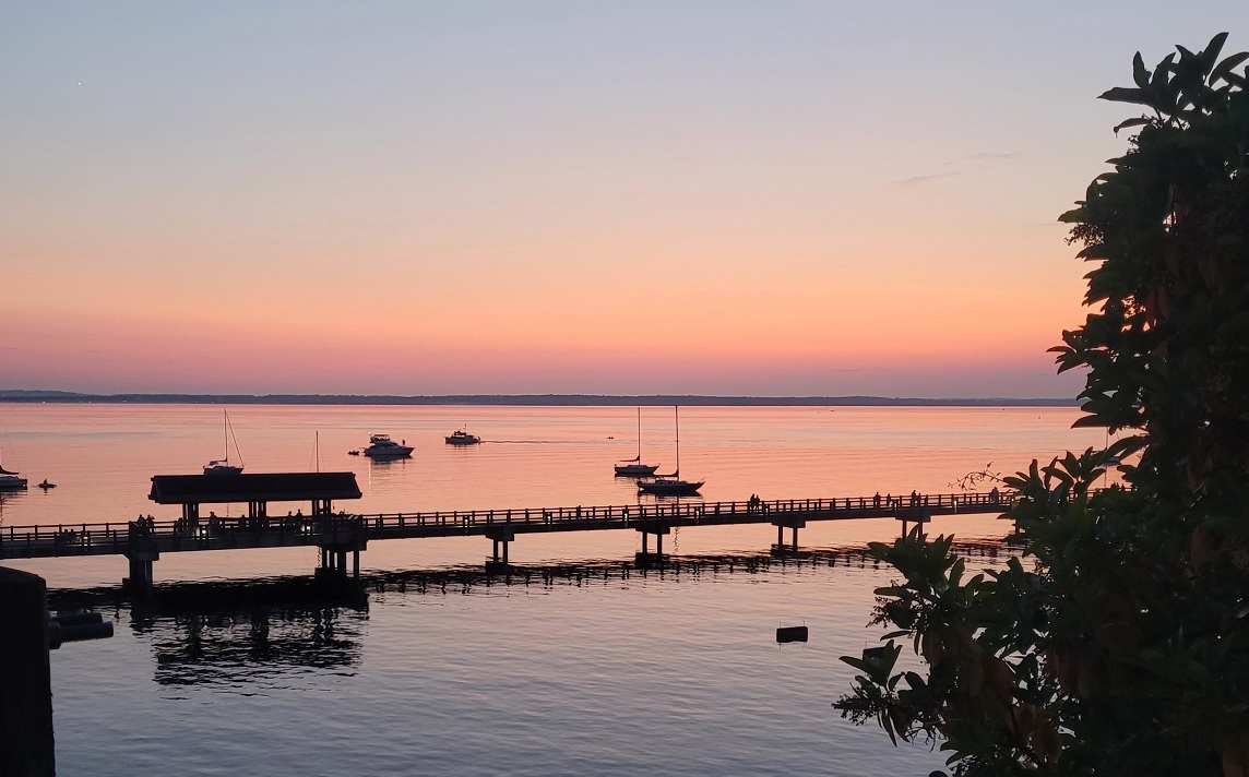Looking west at the sunset over Bellingham Bay from the Taylor Dock boardwalk near Boulevard Park