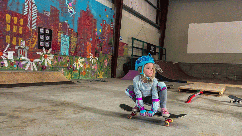 Young girl skating on a skateboard