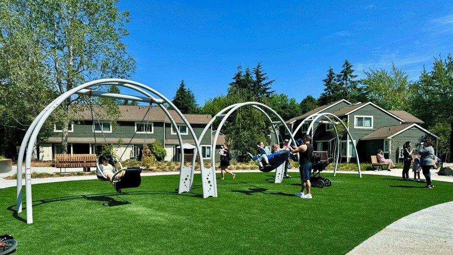 Three swings at Seattle’s inclusive Pathways Park playground offer face-to-face options, group swing time and individual use