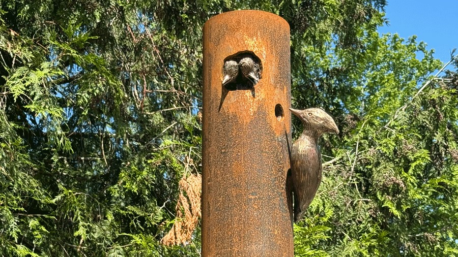 A woodpecker statue on a talking pole at Seattle’s inclusive Pathways Park playground