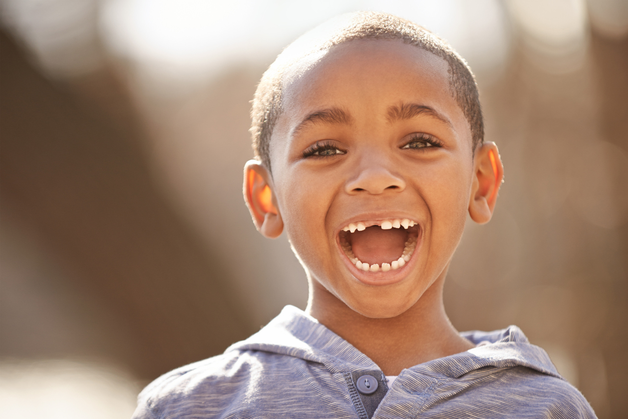 smiling boy with a missing front tooth