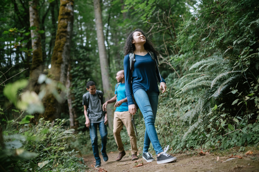 A family hiking on a quiet trail in the woods
