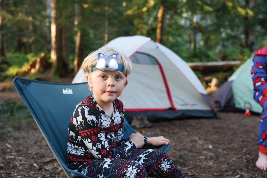 boy siting at a camping site backpacking with kids