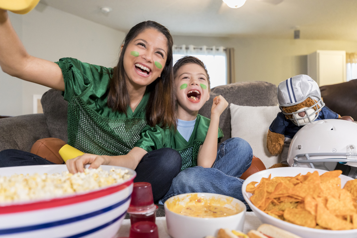 mom and son having fun watching the Super Bowl