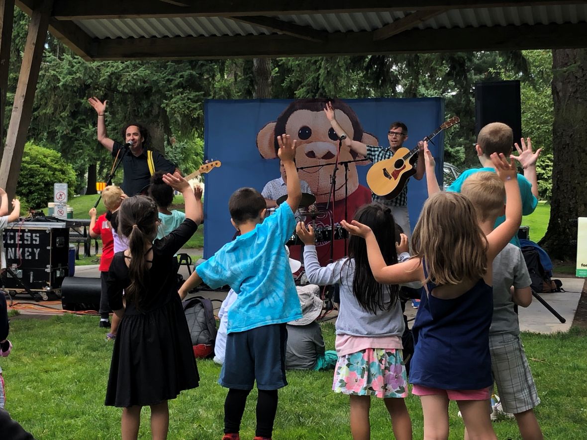 Kids dance along with Recess Monkey at a Seattle concert series in the summer