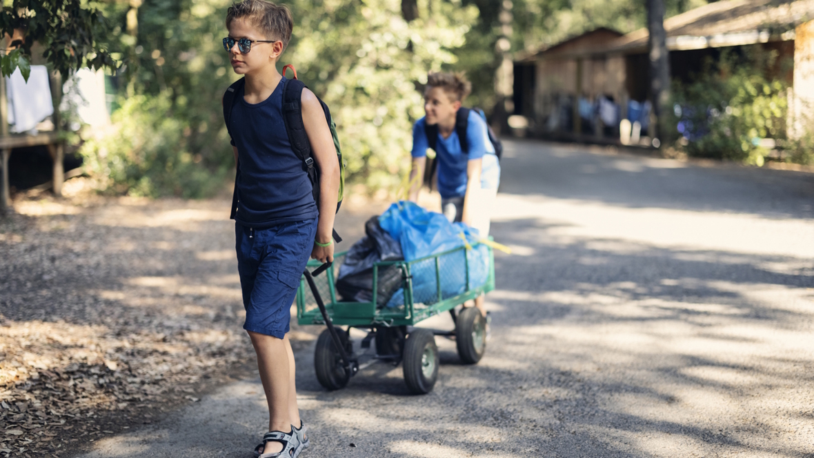 two boys heading to their cabin at summer camp