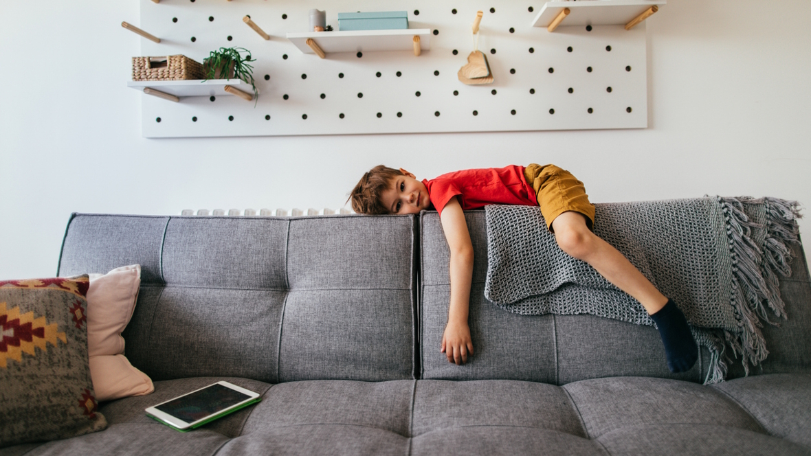 unmotivated child on the back of a couch