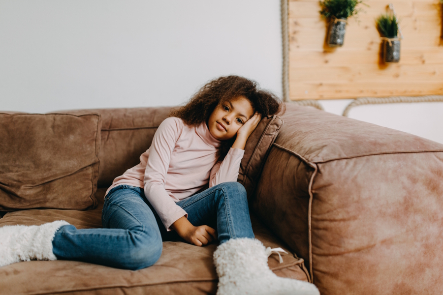 girl sitting on a couch looking unmotivated