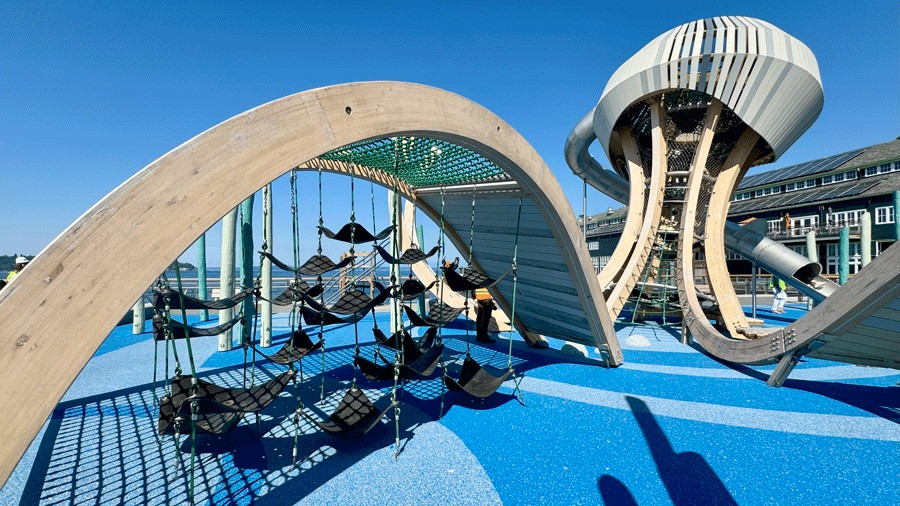 flexform rubber sling seats connected by ropes undre a climbing structure on the new Pier 58 playground