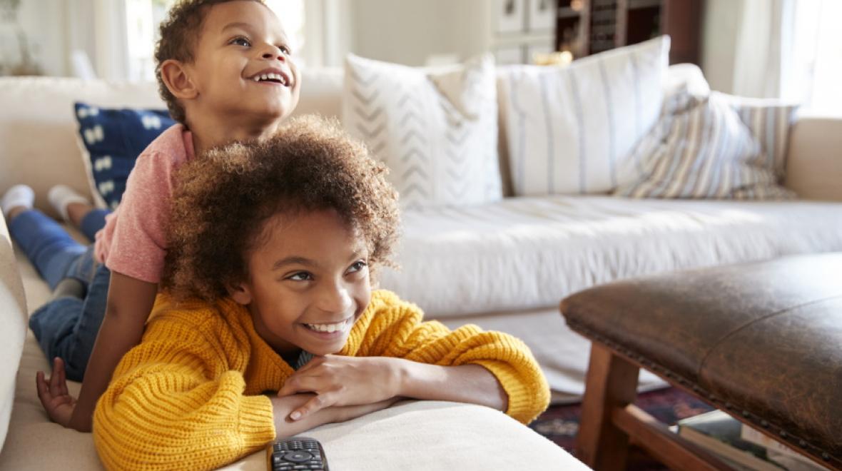 siblings watching tv together