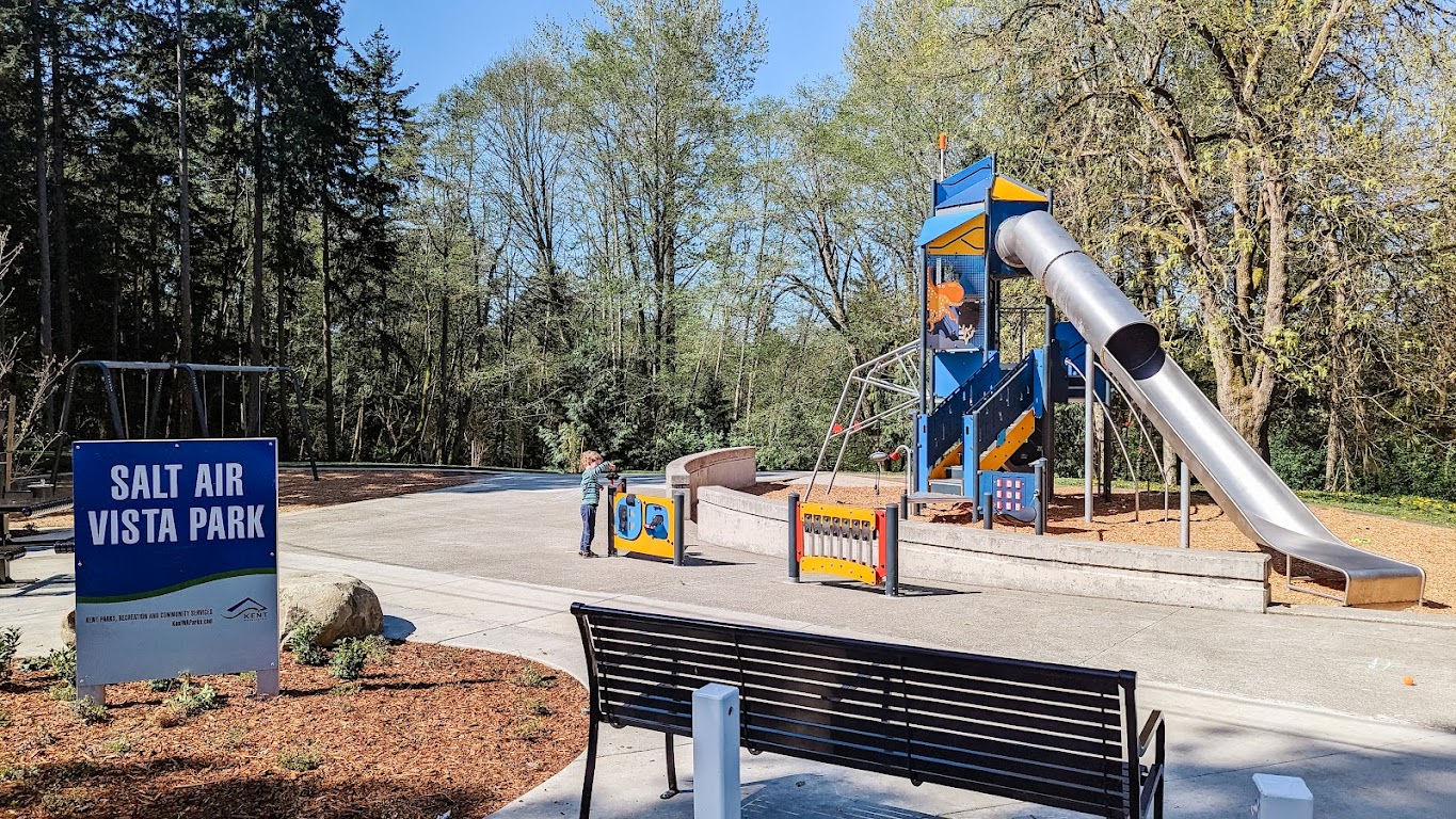 A young boy approaches the play equipment climbing tower at new Salt Air Vista Park playground in Kent, near Seattle