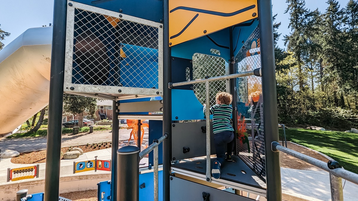 A young boy plays on the climbing structure tower at the new playground at Kent’s Salt Air Vista Park near Seattle