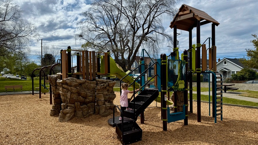 girl climbing play structure at Ferry Park, the newest playground in Tacoma