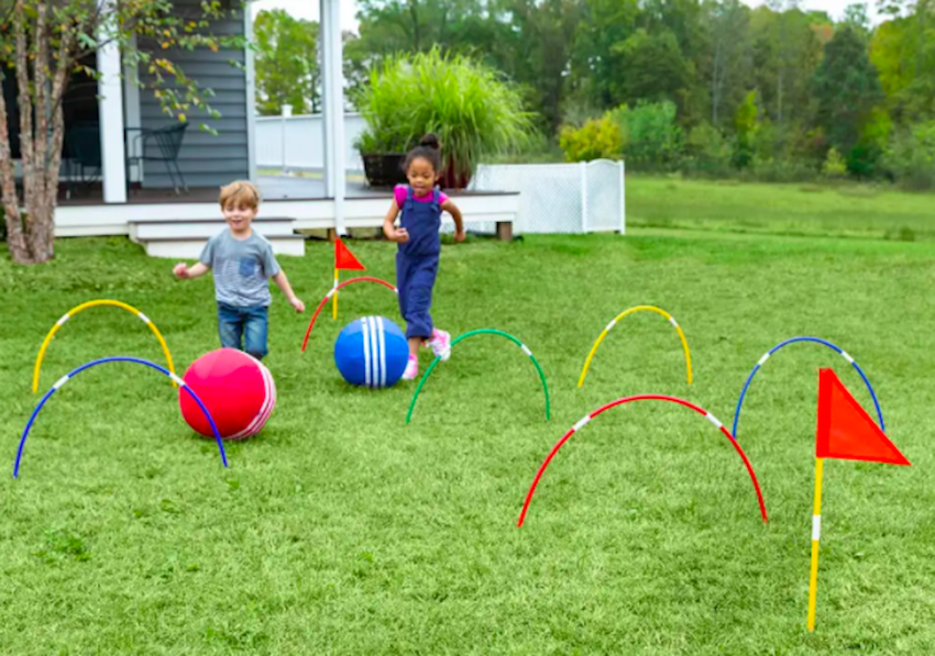 two kids playing kick croquet