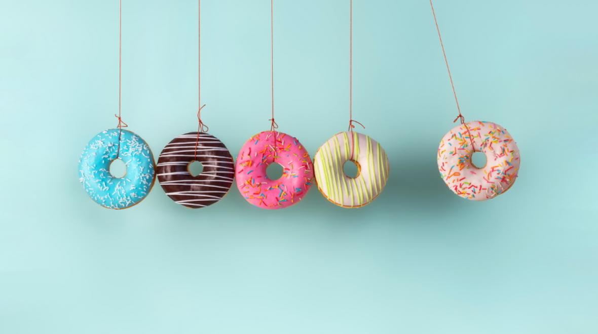 doughnuts on strings in a line on a blue background