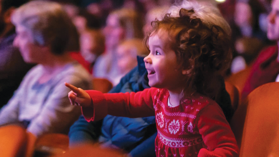 Young girl excited and pointing at the Seattle Symphony
