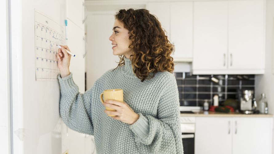 Woman putting things in a calendar