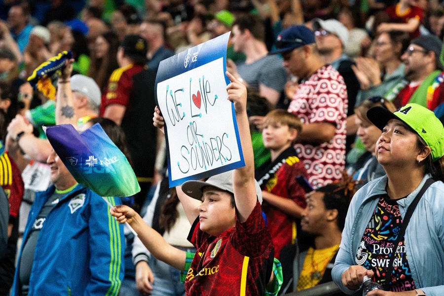 people cheering at a Sounders game